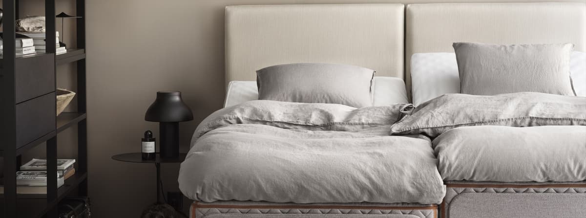 Bedroom interior with the DUX adjustable bed Axion and Flex headboard, showing the adjustable feature